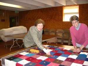 Some quilter tie at tables.